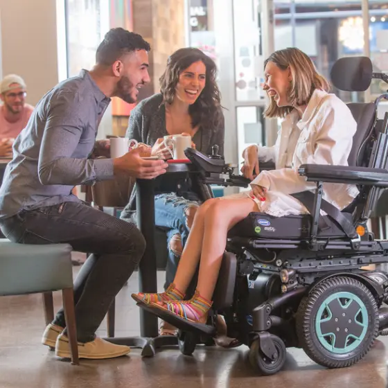Patient enjoys family lunch in TDX SP2 Power Wheelchair, offering superb driving, smart design, comfort, and exceptional stability